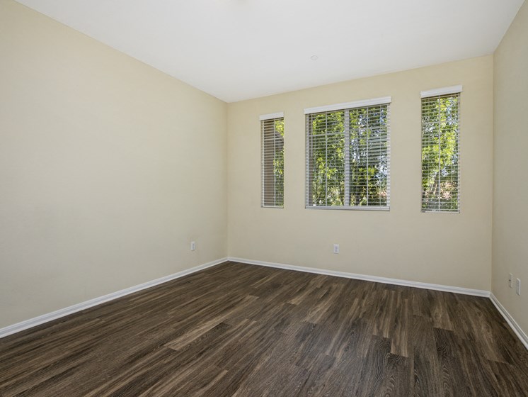 Parkside Villas unfurnished bedroom with wooden floors and window
